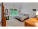 A bedroom with white walls, neutral carpet, a window, and wooden furniture at 1102 High Brook Dr, Waxhaw, NC 28173