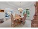 Elegant dining room with a chandelier, large wooden table, and views of the living area at 1102 High Brook Dr, Waxhaw, NC 28173