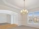 Dining room featuring an archway entry, chandelier and bright windows at 1102 High Brook Dr, Waxhaw, NC 28173