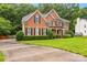 Charming two-story brick home with black shutters, a manicured lawn, and lush landscaping at 1102 High Brook Dr, Waxhaw, NC 28173