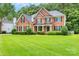 Charming brick home with manicured lawn and landscaping, showing curb appeal and a welcoming entrance at 1102 High Brook Dr, Waxhaw, NC 28173