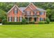 Well-maintained brick home with lush green lawn, showcasing its classic architecture and attractive landscaping at 1102 High Brook Dr, Waxhaw, NC 28173