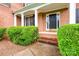 Close-up of brick steps leading to a black front door with sidelights and decorative trim at 1102 High Brook Dr, Waxhaw, NC 28173