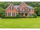 Charming brick two-story home with a well-manicured lawn and neatly trimmed hedges at 1102 High Brook Dr, Waxhaw, NC 28173