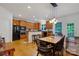 A kitchen with wooden cabinets, black appliances, a center island with bar seating and a dining table at 1102 High Brook Dr, Waxhaw, NC 28173