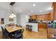 Modern kitchen and dining nook featuring hardwood floors, breakfast bar, and ample natural light at 1102 High Brook Dr, Waxhaw, NC 28173