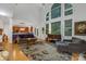 Open-concept living room with high ceilings, large windows, and hardwood floors, offering a bright and airy atmosphere at 1102 High Brook Dr, Waxhaw, NC 28173
