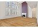 Bright living room featuring a fireplace, large windows, and hardwood floors at 1102 High Brook Dr, Waxhaw, NC 28173