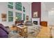 Cozy living room with a fireplace, a plush rug, and comfortable seating with views of the outdoor scenery at 1102 High Brook Dr, Waxhaw, NC 28173