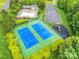 Aerial view of community tennis courts, pool, playground, parking, and greenery in the neighborhood at 1102 High Brook Dr, Waxhaw, NC 28173