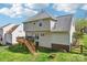 Backyard with deck, stairs, well-maintained lawn, and privacy fence surrounding the property at 11615 Hidden Grove Trl, Charlotte, NC 28215