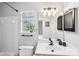 Clean bathroom with a plant on the window sill and a modern sink at 11615 Hidden Grove Trl, Charlotte, NC 28215