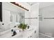 Bathroom featuring double sinks, matte black hardware, and a large mirror at 11615 Hidden Grove Trl, Charlotte, NC 28215