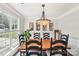 Elegant dining room featuring a large wooden table and chandelier lighting at 11615 Hidden Grove Trl, Charlotte, NC 28215