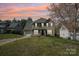 Charming two-story home with attached garage, lawn, and professional landscaping at 11615 Hidden Grove Trl, Charlotte, NC 28215
