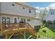 The exterior of this home has a wooden deck with stairs to the yard, a grill, and windows facing the backyard at 11615 Hidden Grove Trl, Charlotte, NC 28215