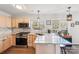 Bright kitchen featuring stainless steel appliances, granite countertops, and hardwood floors at 11615 Hidden Grove Trl, Charlotte, NC 28215