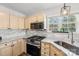 Bright kitchen featuring stainless steel appliances, granite countertops, and hardwood floors at 11615 Hidden Grove Trl, Charlotte, NC 28215