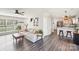 Open-concept living area with hardwood floors, a modern sofa, and kitchen view at 11615 Hidden Grove Trl, Charlotte, NC 28215