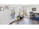Cozy sitting room with hardwood floors, access to the outdoor deck, and ample natural light from surrounding windows at 11615 Hidden Grove Trl, Charlotte, NC 28215