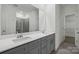 Modern bathroom features double sinks, a large mirror, and a walk-in shower with glass doors at 1234 Morehead Dr, Salisbury, NC 28144