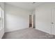 An empty bedroom with neutral carpet, a large window, and access to another room at 1234 Morehead Dr, Salisbury, NC 28144