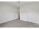 An empty bedroom with neutral carpet with access to another room at 1234 Morehead Dr, Salisbury, NC 28144