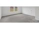 Cozy bedroom with plush gray carpet, bright windows, and neutral paint at 1234 Morehead Dr, Salisbury, NC 28144