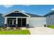 Charming single-Gathering home with stone accents, white siding, manicured lawn, and two-car garage on a sunny day at 1234 Morehead Dr, Salisbury, NC 28144