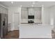 Bright kitchen showcasing gray cabinets, stainless steel appliances, a white countertop island, and elegant backsplash tiles at 1234 Morehead Dr, Salisbury, NC 28144