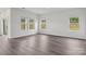 Spacious living room with wood-look floors, three bright windows, and neutral paint at 1234 Morehead Dr, Salisbury, NC 28144