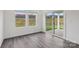 Bright living space with wood-look floors, sliding glass doors to patio, and a pair of windows at 1234 Morehead Dr, Salisbury, NC 28144