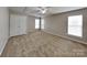 Bedroom features carpet, neutral paint, ceiling fan, and two windows that provide natural light at 1240 Periwinkle Dr, Waxhaw, NC 28173