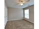 Cozy bedroom featuring neutral walls, plush carpeting, and a ceiling fan for added comfort at 1240 Periwinkle Dr, Waxhaw, NC 28173
