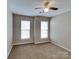 Inviting bedroom featuring two windows that provide natural light, neutral walls, and plush carpeting at 1240 Periwinkle Dr, Waxhaw, NC 28173