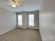 Bright bedroom with two windows offering natural light, neutral walls, and plush carpeting at 1240 Periwinkle Dr, Waxhaw, NC 28173