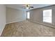 Bedroom with carpet, neutral paint, ceiling fan, and two windows that provide natural light at 1240 Periwinkle Dr, Waxhaw, NC 28173