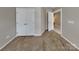 Bedroom featuring neutral walls, plush carpeting, and a closet for storage and door to another room at 1240 Periwinkle Dr, Waxhaw, NC 28173