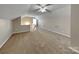 Spacious bonus room featuring neutral walls, plush carpeting, and a stylish pendant light at 1240 Periwinkle Dr, Waxhaw, NC 28173