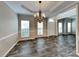 Elegant dining room features laminate floors, a tray ceiling, and a chandelier at 1240 Periwinkle Dr, Waxhaw, NC 28173