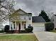 Charming two-story home with a red front door, white pillars, and manicured landscaping at 1240 Periwinkle Dr, Waxhaw, NC 28173