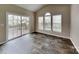 Living room with a vaulted ceiling, three windows and sliding glass doors to outside deck at 1240 Periwinkle Dr, Waxhaw, NC 28173