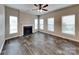 Inviting living room with laminate floors, a fireplace, and multiple windows at 1240 Periwinkle Dr, Waxhaw, NC 28173