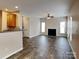 Open layout living room with laminate floors, fireplace, and view of the kitchen at 1240 Periwinkle Dr, Waxhaw, NC 28173