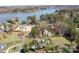 Aerial view of estate at 127 Castle Dr featuring lake, pool, and large manicured lawn at 127 Castle Dr, Mooresville, NC 28117