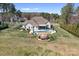 Aerial view of home featuring a large backyard pool, patio, and expansive lawn on a sunny day at 127 Castle Dr, Mooresville, NC 28117