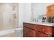Bathroom with granite counters, wood cabinets, and a tiled walk-in shower with a glass door at 127 Castle Dr, Mooresville, NC 28117