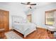 Bright bedroom featuring hardwood floors, white walls, and a well-lit window with wooden blinds at 127 Castle Dr, Mooresville, NC 28117