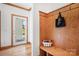 Charming entryway with wood paneling, coat hooks, bench, and bright natural light at 127 Castle Dr, Mooresville, NC 28117