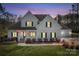 Charming two-story home with a well-manicured lawn at dusk at 127 Castle Dr, Mooresville, NC 28117